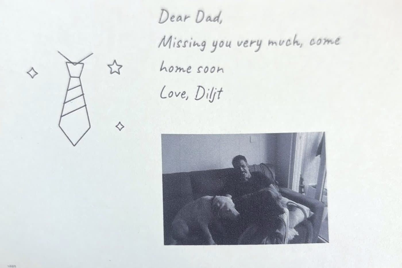 A handwritten card reading Dear Dad, missing you very much, come home soon, with a drawn tie, stars and a black-and-white photo