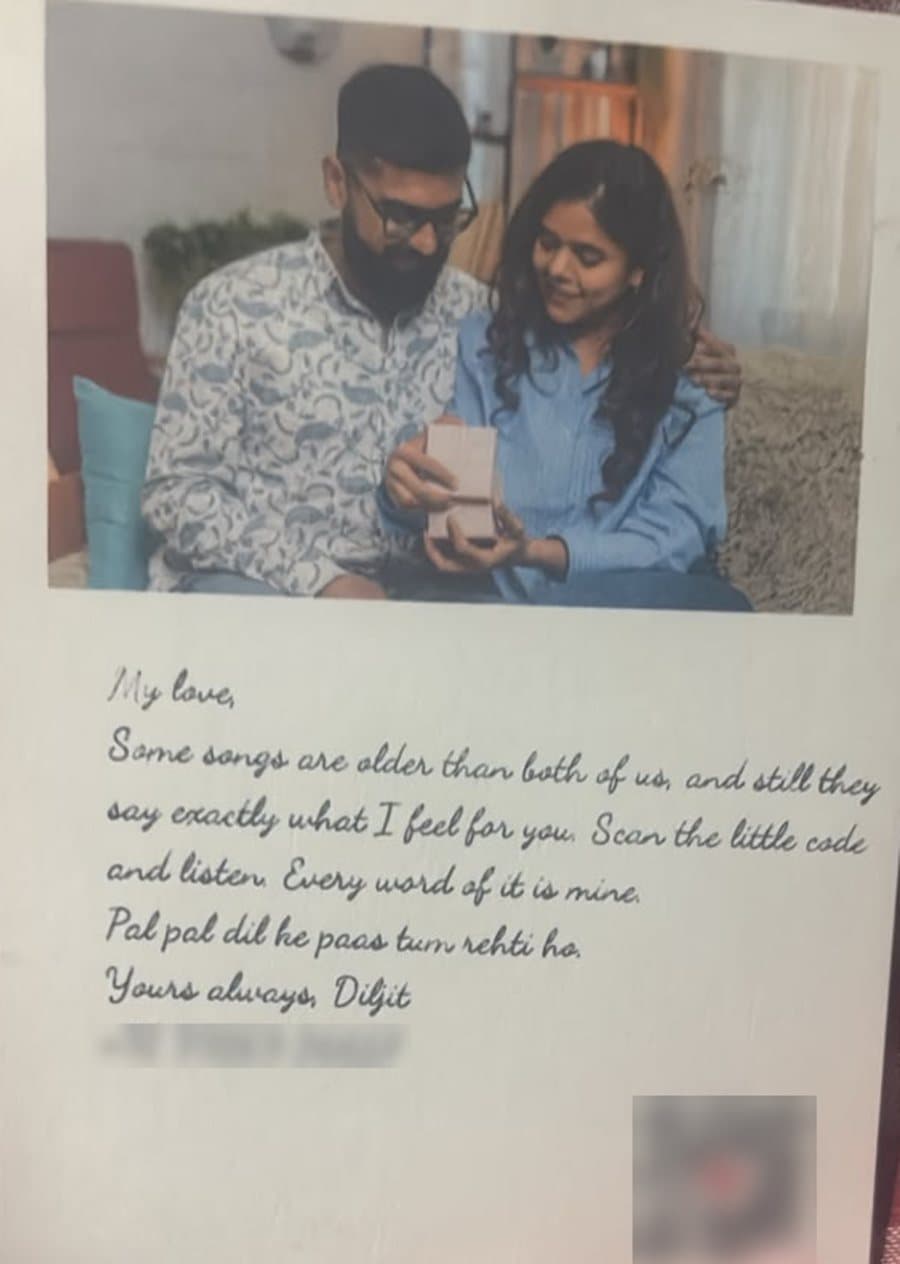 A card with a couple's photo above a handwritten love letter in a flowing script